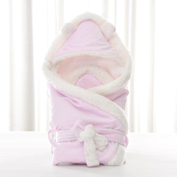Newborn baby being hugged and swaddled by baby - Image 2